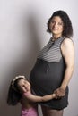 A young beautiful pregnant mother with her two years old daughter Royalty Free Stock Photo