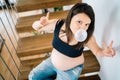 Beautiful pregnant woman chewing bubble gum and having fun Royalty Free Stock Photo