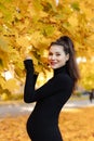 Young beautiful pregnant woman with dark hair in a black tight dress Royalty Free Stock Photo