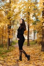 Young beautiful pregnant woman with dark hair in a black tight dress Royalty Free Stock Photo