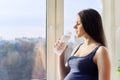 Young beautiful pregnant woman drinking water from bottle Royalty Free Stock Photo