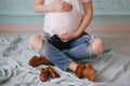 Young beautiful pregnant woman posing in a vintage interior