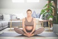 Young beautiful pregnant woman practising yoga at home in her living room. Motherhood, pregnancy, healthy lifestyle Royalty Free Stock Photo