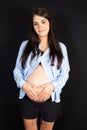Young beautiful pregnant woman standing on black background Royalty Free Stock Photo