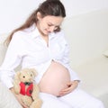 Young beautiful pregnant woman stroking her tummy Royalty Free Stock Photo