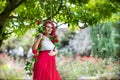 Young beautiful pregnant woman in a swing decorated with red roses Royalty Free Stock Photo