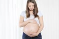 Young beautiful pregnant woman touching her belly with hands Royalty Free Stock Photo