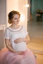 Young beautiful pregnant woman in vintage interior