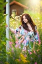 Young beautiful red hair woman in multicolored blouse in a sunny day. Portrait of attractive long hair female in nature