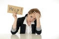 Beautiful young business woman overwhelmed and tired holding a help sign Royalty Free Stock Photo