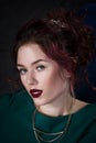 Young beautiful red-haired caucasian woman with professional makeup in green dress Royalty Free Stock Photo