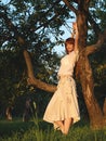 Young beautiful redhaired woman in apple orchard Royalty Free Stock Photo