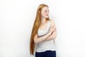 Young beautiful redhead beginner model woman in white t-shirt blue jeans practicing posing showing emotions standing against white Royalty Free Stock Photo