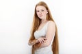 Young beautiful redhead beginner model woman in white t-shirt blue jeans practicing posing showing emotions standing against white Royalty Free Stock Photo