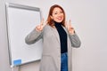 Young beautiful redhead businesswoman doing business presentation using magnetic board smiling looking to the camera showing Royalty Free Stock Photo