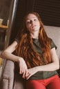 Young beautiful redhead hipster woman with no make up relaxing at home Royalty Free Stock Photo