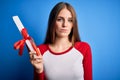 Young beautiful redhead student woman holding university diploma degree with a confident expression on smart face thinking serious Royalty Free Stock Photo