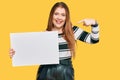 Young beautiful redhead woman holding blank empty banner pointing finger to one self smiling happy and proud Royalty Free Stock Photo