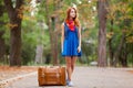 Young beautiful redhead woman with suitcase Royalty Free Stock Photo