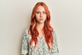 Young beautiful redhead woman wearing casual clothes with serious expression on face Royalty Free Stock Photo