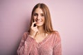 Young beautiful redhead woman wearing casual sweater over isolated pink background looking confident at the camera with smile with Royalty Free Stock Photo