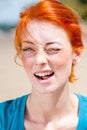 Young beautiful redhead woman winking Royalty Free Stock Photo