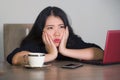 Beautiful sad and depressed Asian Chinese businesswoman working in stress at office computer desk feeling overwhelmed and frustrat Royalty Free Stock Photo