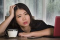 Young beautiful sad and depressed Asian Chinesebusiness woman working exhausted and frustrated at office computer desk with rain o Royalty Free Stock Photo