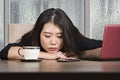 Young beautiful sad and depressed Asian Japanese businesswoman working exhausted and frustrated at office computer desk with rain Royalty Free Stock Photo