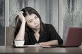 Young beautiful sad and depressed Asian Japanese businesswoman working exhausted and frustrated at office computer desk with rain Royalty Free Stock Photo