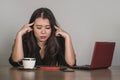 Beautiful sad and depressed Asian Korean businesswoman working in stress at office computer desk feeling overwhelmed and frustrate Royalty Free Stock Photo