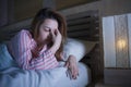 Young beautiful Asian Korean girl lying on bed late night awake looking thoughtful suffering insomnia sleeping disorder feeling Royalty Free Stock Photo