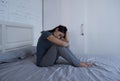 Beautiful sad and depressed Latin woman sitting on bed at home f Royalty Free Stock Photo