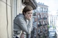 Young beautiful sad and unhappy woman suffering from depression looking thoughtful on the balcony Royalty Free Stock Photo