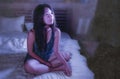 Young beautiful sad and worried Asian Korean woman awake at night sleepless in bed looking thoughtful and pensive suffering insomn Royalty Free Stock Photo