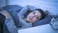 Young beautiful sad and worried latin woman suffering insomnia and sleeping disorder problem unable to sleep late at night lying o Royalty Free Stock Photo