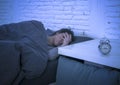 Young beautiful sad and worried latin woman suffering insomnia and sleeping disorder problem unable to sleep late at night lying o Royalty Free Stock Photo