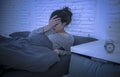 Young beautiful sad and worried latin woman suffering insomnia and sleeping disorder problem unable to sleep late at night lying o Royalty Free Stock Photo