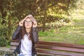 Young beautiful school or college girl with glasses sitting on the bench in the park reading the books and study for exam Royalty Free Stock Photo