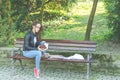 Young beautiful school or college girl with glasses sitting on the bench in the park reading the books and study for exam Royalty Free Stock Photo