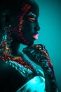 Young sensual woman in fluorescent paint makeup