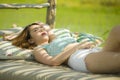 Young beautiful and Asian Korean woman lying comfortable at holidays resort garden bed having sunbath tanning relaxed and Royalty Free Stock Photo