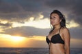 Young beautiful and asian woman in black bikini posing relaxed having fun at sunset beach in Bali island of Indonesia Royalty Free Stock Photo