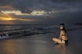 Young beautiful and asian woman in black bikini posing relaxed having fun at sunset beach in Bali island of Indonesia Royalty Free Stock Photo