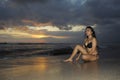 Young beautiful and asian woman in black bikini posing relaxed having fun at sunset beach in Bali island of Indonesia Royalty Free Stock Photo