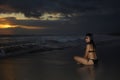 Young beautiful and asian woman in black bikini posing relaxed having fun at sunset beach in Bali island of Indonesia Royalty Free Stock Photo