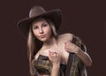 Young beautiful girl in fur waistcoat and cowboy hat Royalty Free Stock Photo