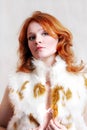 Young beautiful red woman in fur Royalty Free Stock Photo