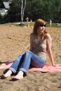 Beautiful red womani laying on sea beach Royalty Free Stock Photo