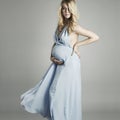 Young beautiful and stylish pregnant woman in blue dress Royalty Free Stock Photo